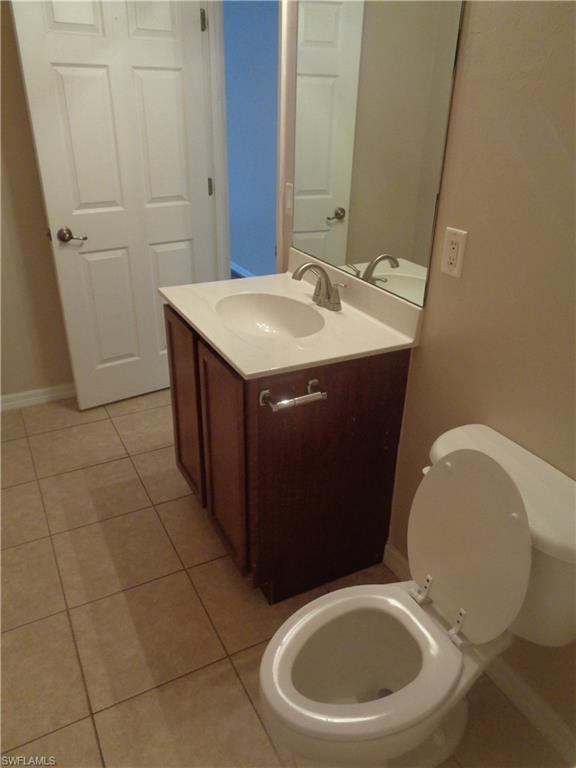 Second Bathroom with hand sink vanity and toilet featuring tile flooring