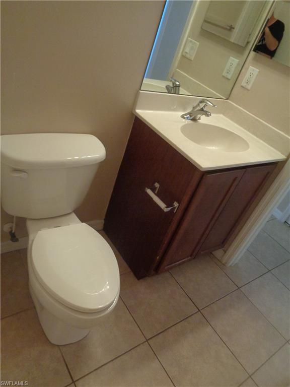 Third Bathroom with hand sink vanity and toilet featuring tile flooring