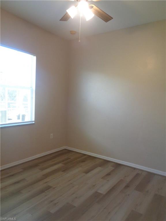 Guest Bedroom 2 with wood-like flooring and ceiling fan