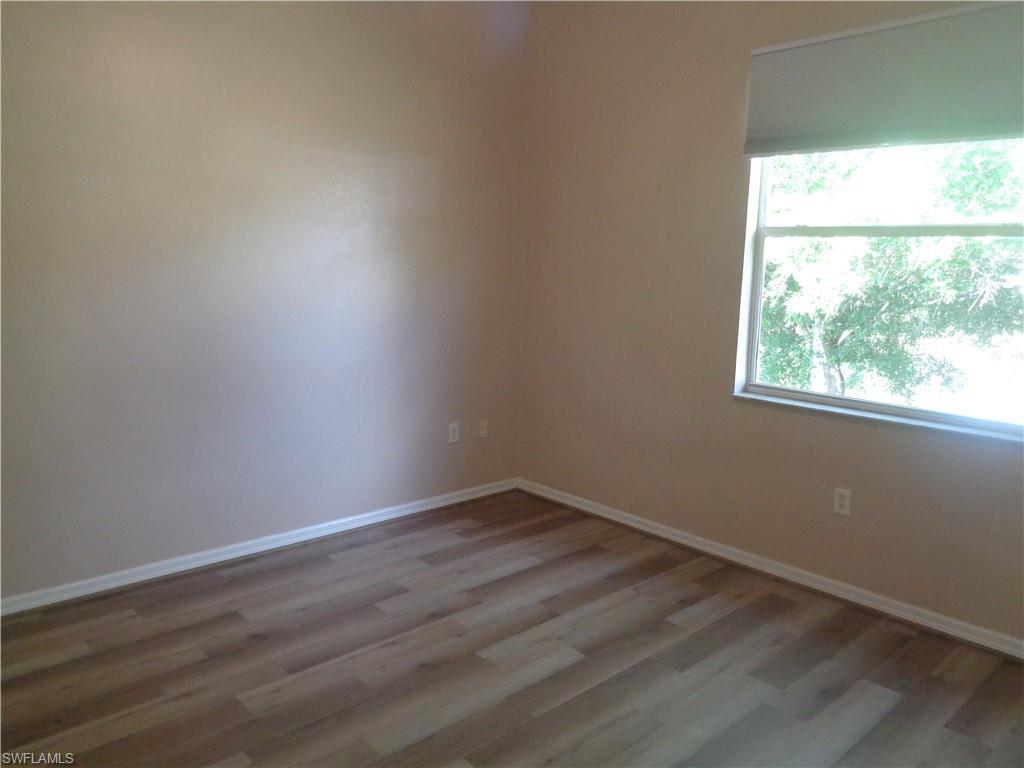 Guest Bedroom 1 with wood-like flooring