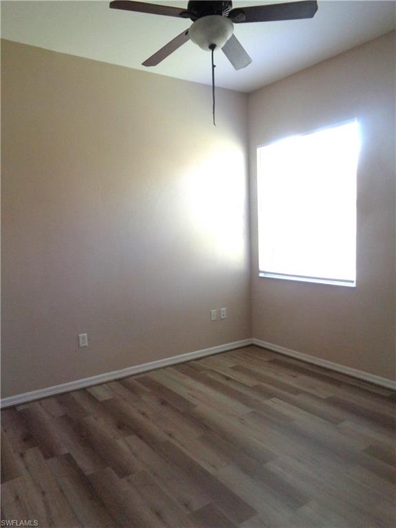 Guest Bedroom 3 with wood-like flooring and ceiling fan
