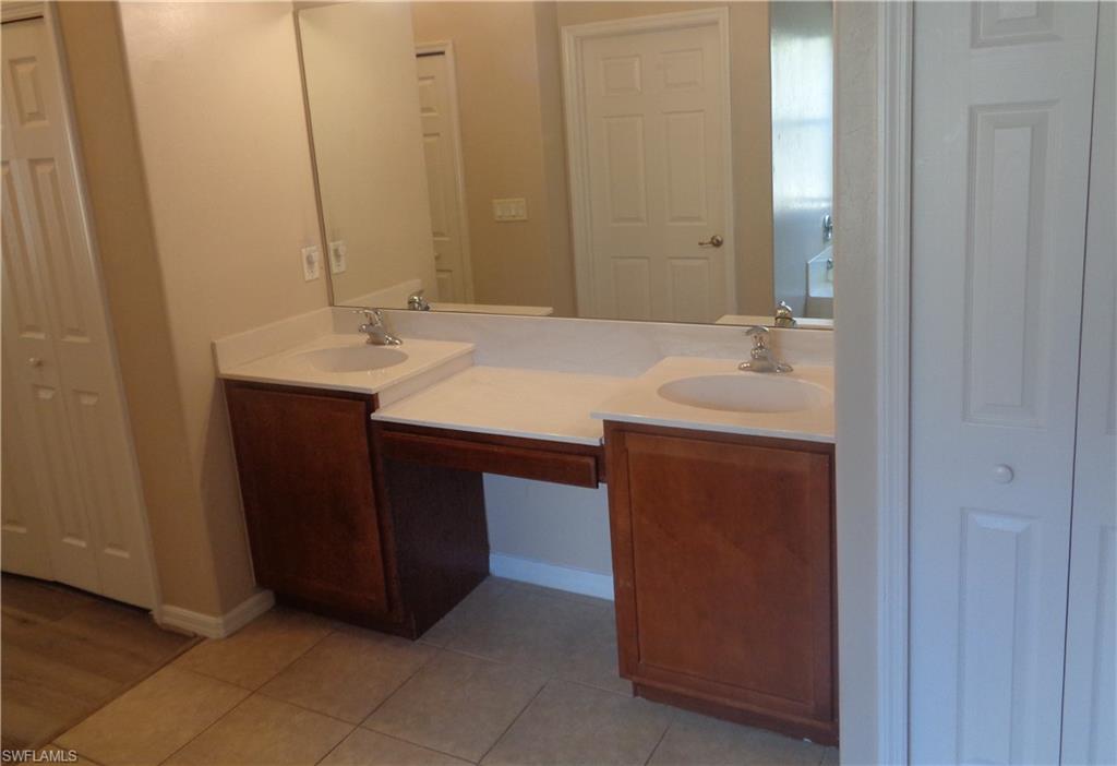 View of the Master Bedroom's bathroom with double sink vanity and tile flooring