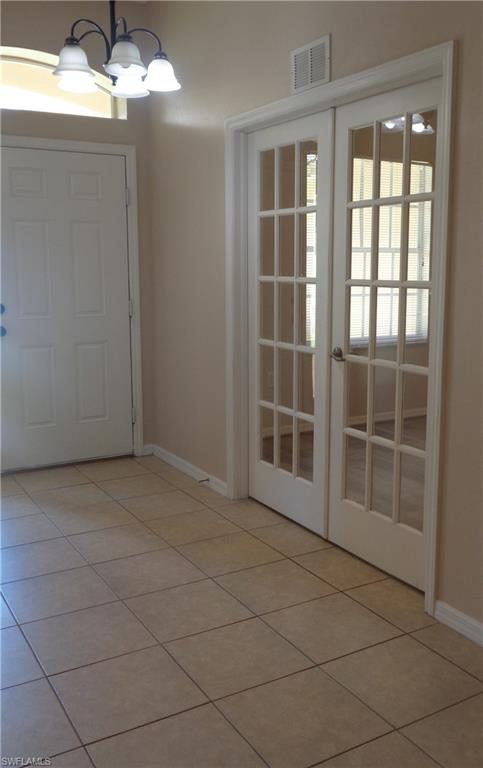 View of entry and Den, featuring tile flooring