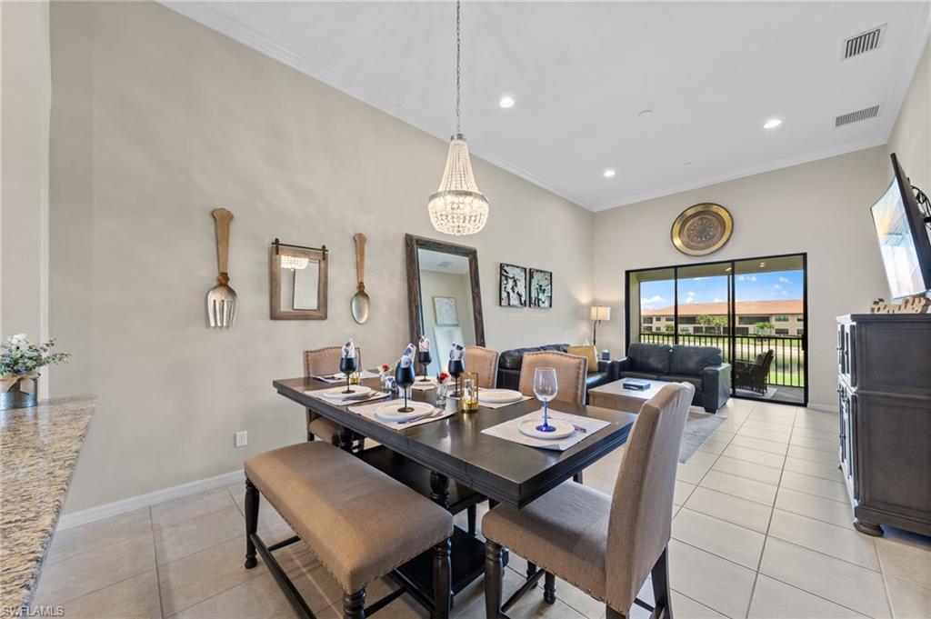 Dining area featuring a crystal chandelier, tile flooring, and light-colored walls