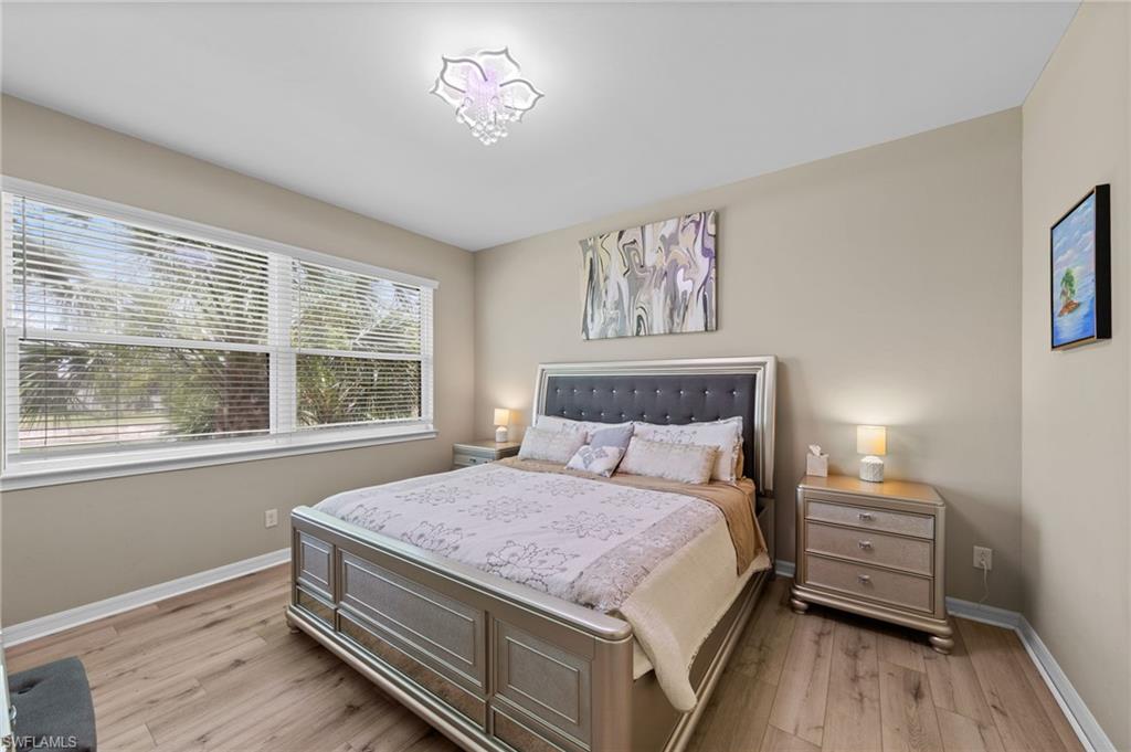 Spacious room featuring wood-finish flooring and neutral wall tones