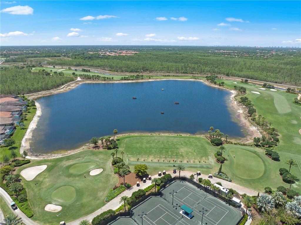 Expansive aerial showcasing a significant body of water bordered by a golf course and residential properties