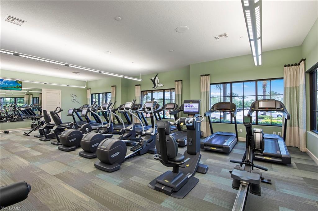 Fitness center featuring multiple treadmills, elliptical machines, and stationary bikes