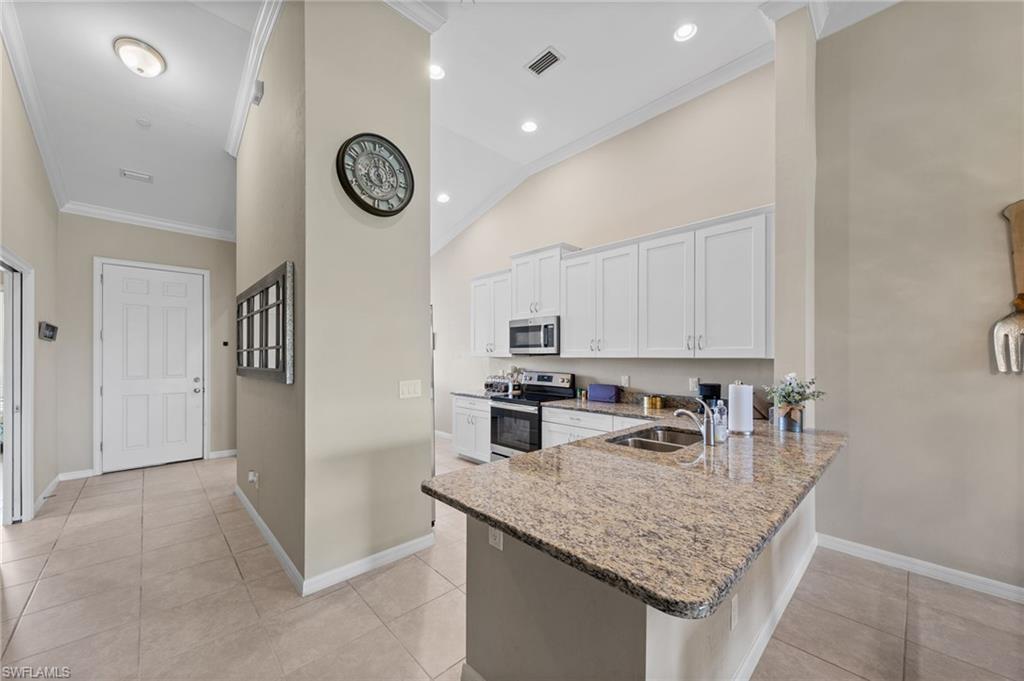 Kitchen bar with a granite countertop and dual basin sink