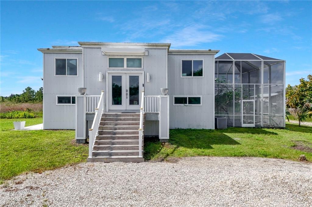Front of home with large screened in gardening-or lanai space