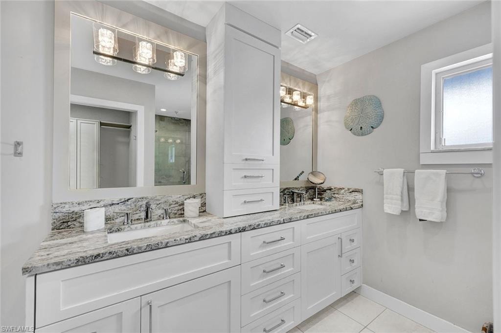 Primary Bath with stone counters and tower of drawers