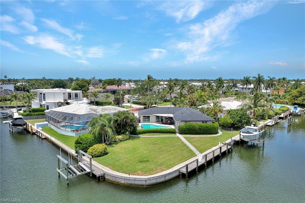 60' YACHT or Larger, 20,000# Lift, Jet Skis Lift -200' SEAWALL on .37 ACRE TIP LOT - 3 BOAT DOCKS Remodeled Cottage and New Construction ENGINEERED POLANS by Falcon Design!!!