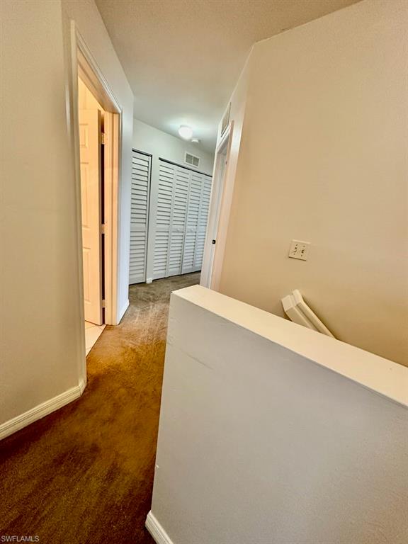 View leaving Primary to Hallway's Second Bath, AC Closet, Utility Closet with W/D and Second and Third Bedrooms