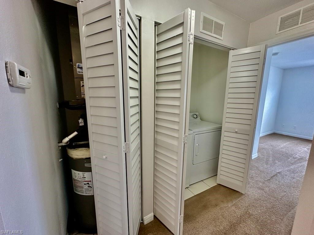 View of hall way AC/Air Handler Closet along with entrydoor to Third [front] bedroom and Utility w/D Closet