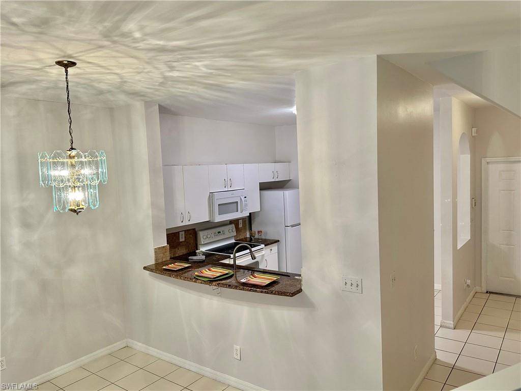 View of Dining w/Chandelier and Breakfast Bar