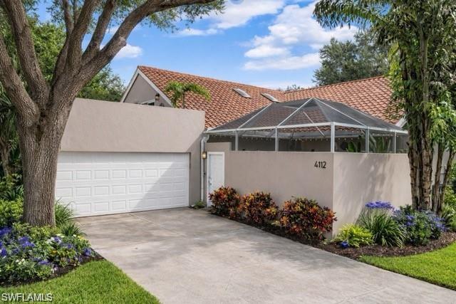 front exterior Courtyard style home with 2 car attached garage