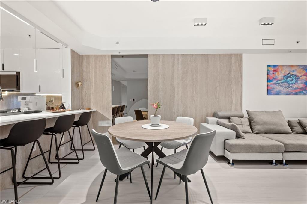 Open-concept living space featuring light wood-finish flooring and recessed lighting