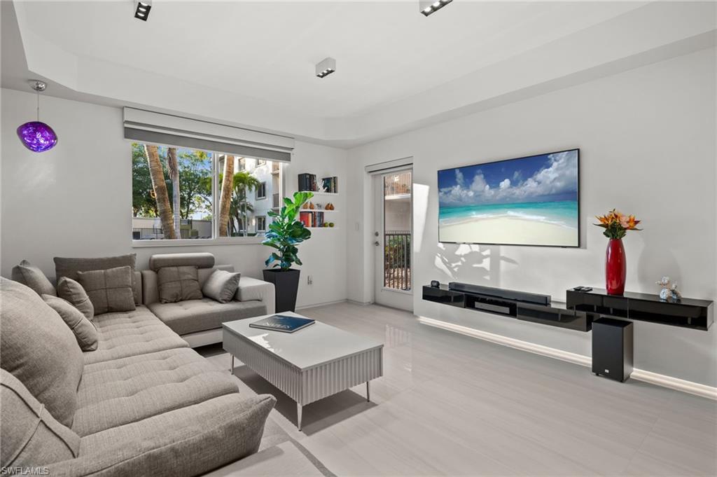 Bright living space featuring light-toned flooring and white walls