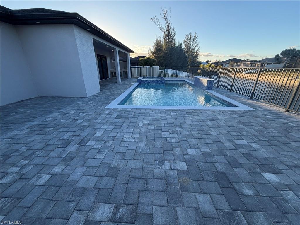 super large paved pool area with outdoor bath