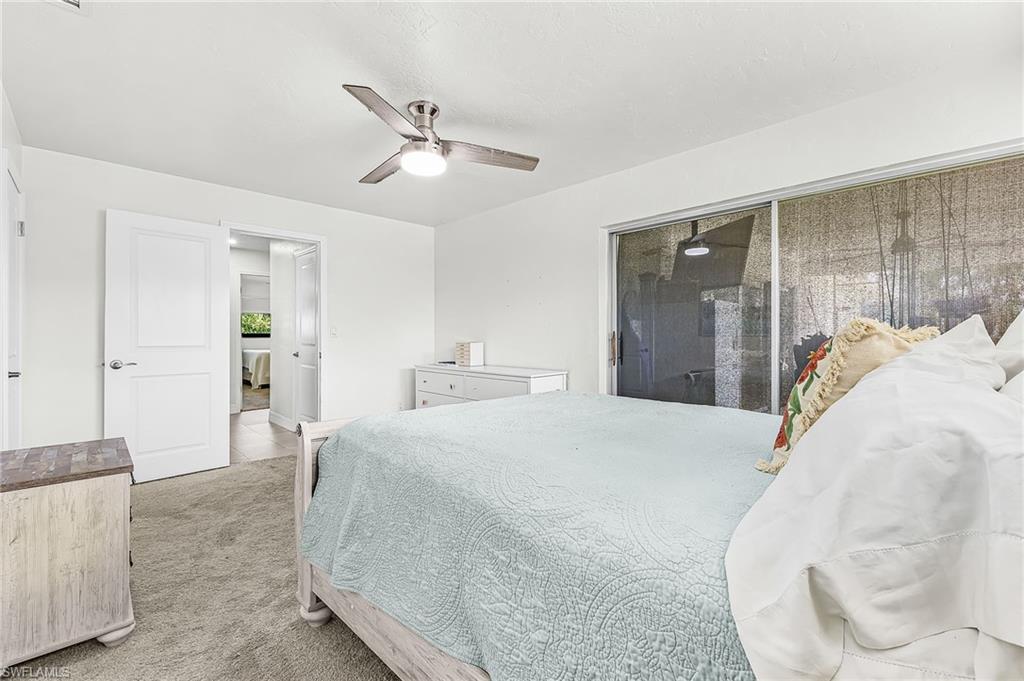 Primary bedroom with water view and sliders to the lanai
