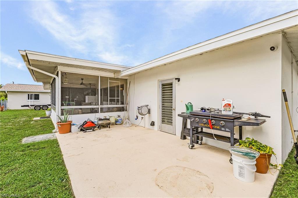 Outside open patio with door to the garage and lots of GRILLING ROOM or Sun bathing space