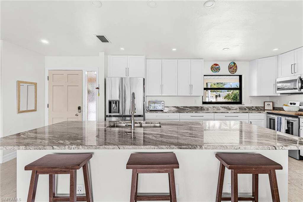 Totally remodeled kitchen with large island for breakfast bar and entertaining