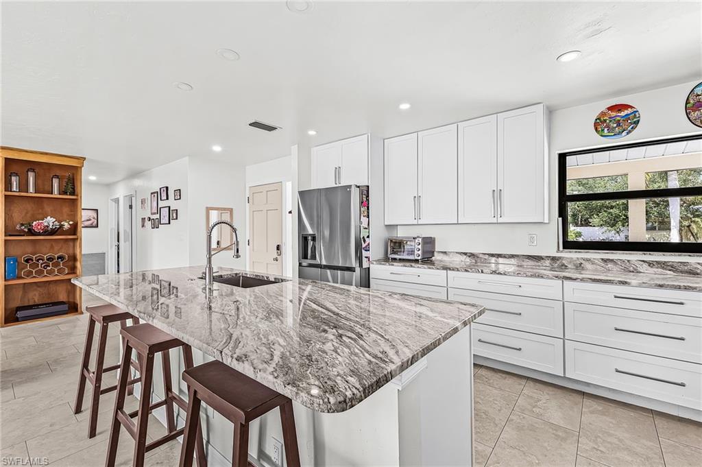 Newer kitchen, new impact windows, tile in all common areas