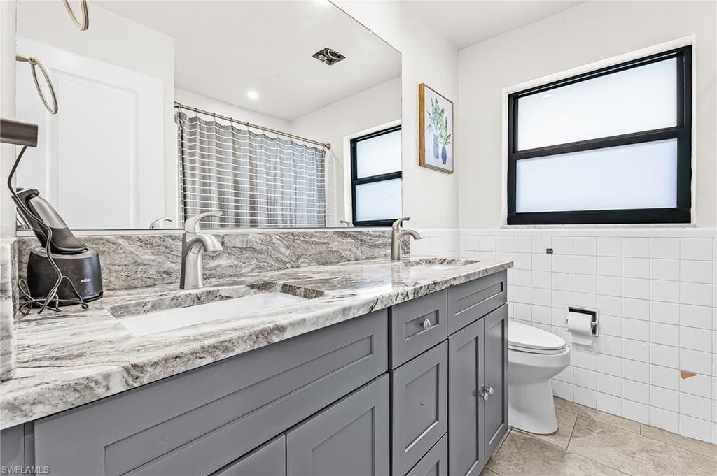 Guest Bathroom with new vanity and newer tile floors and impact window
