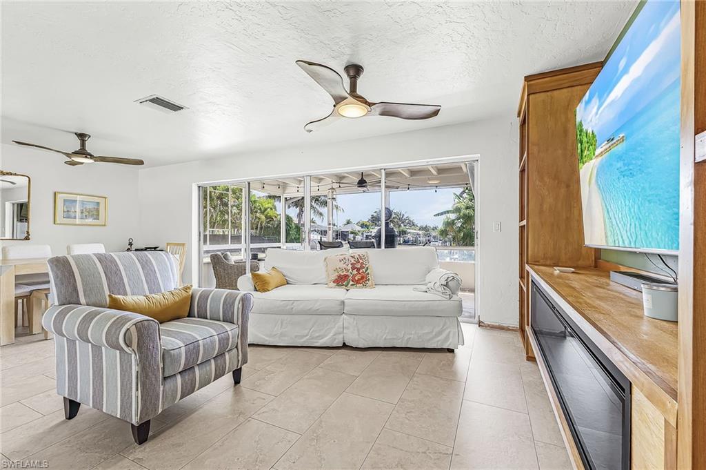 Great room with sliders to the under cover screened patio