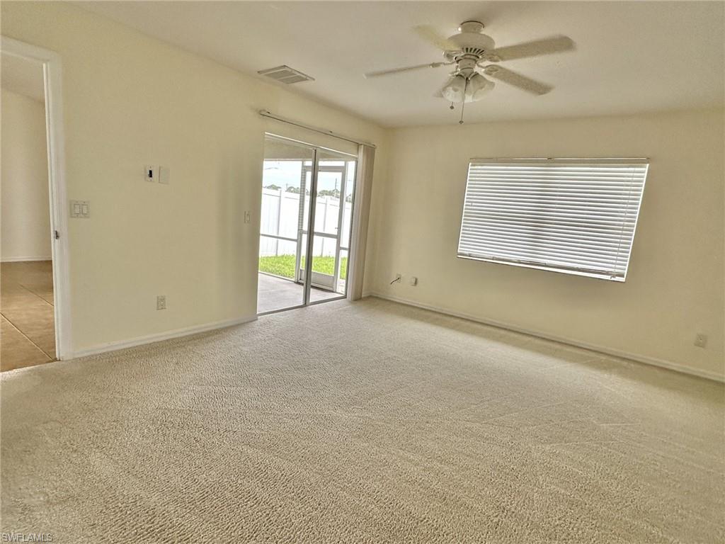 2306 view of primary bedroom with entry doorway, double slider to lanai under truss