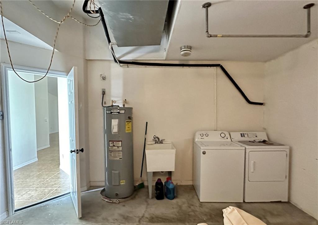 2306 view of garage with W/D hookup/waterheater/utility tub/air handler/auto garatge door opener and entry door