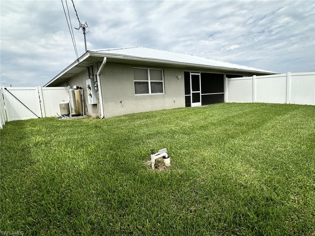2306 view from SW corner of canopied water treatment system/storage/fenced gate