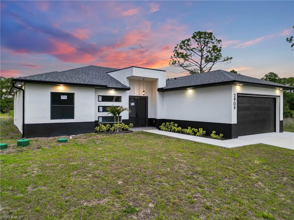 Modern single-story residence featuring a striking black and white exterior