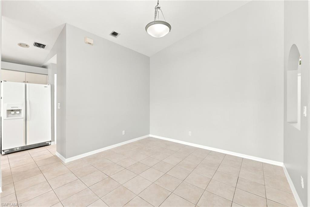 Open concept room with neutral wall tones and tile flooring