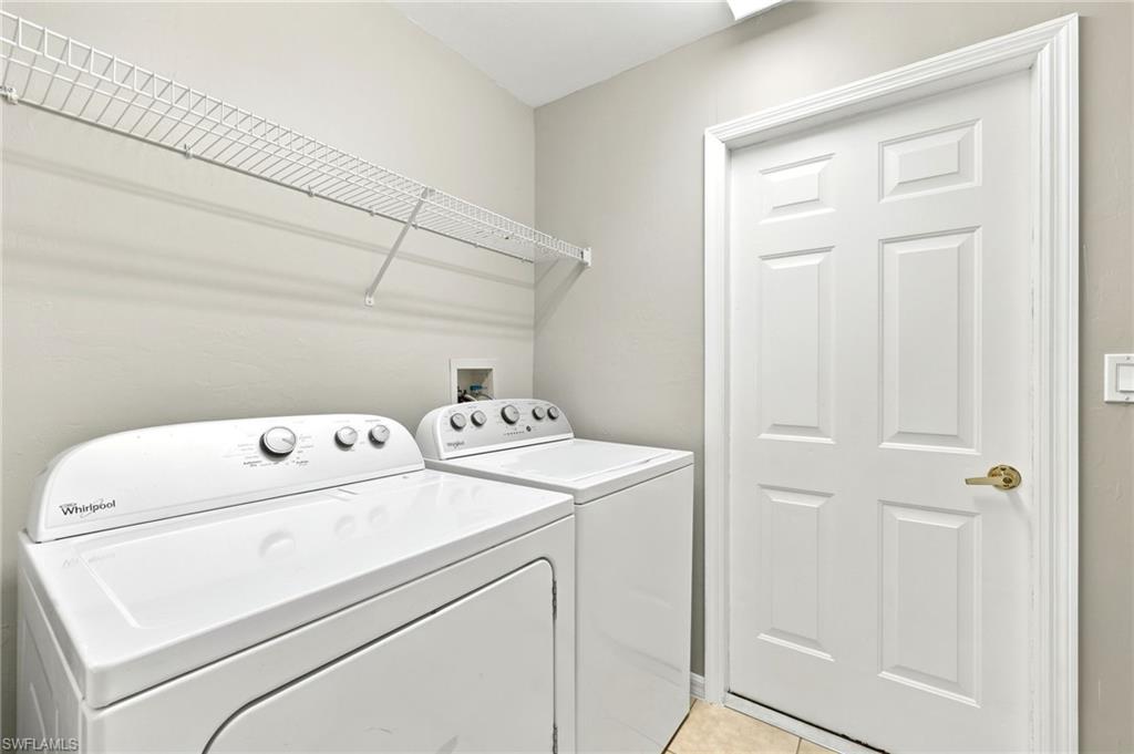 Dedicated laundry area featuring a white wire shelving unit and light beige wall paint