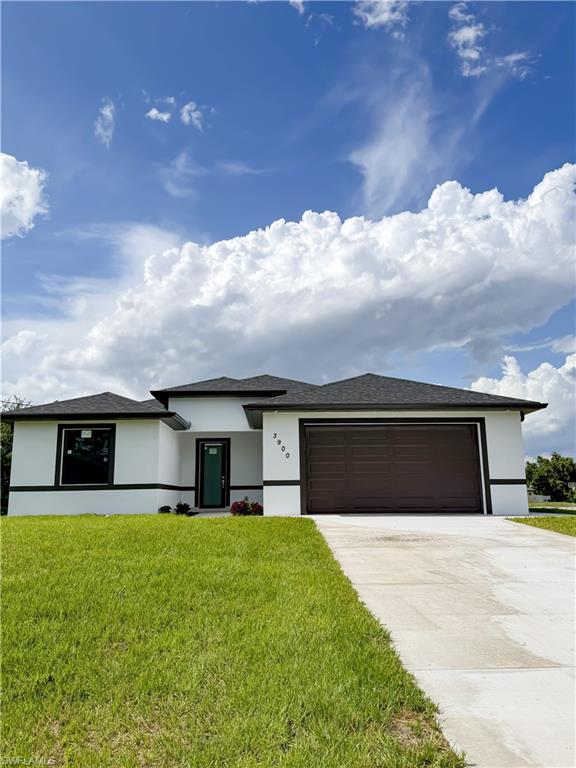 Contemporary single-story residence featuring a white stucco facade with black trim accents