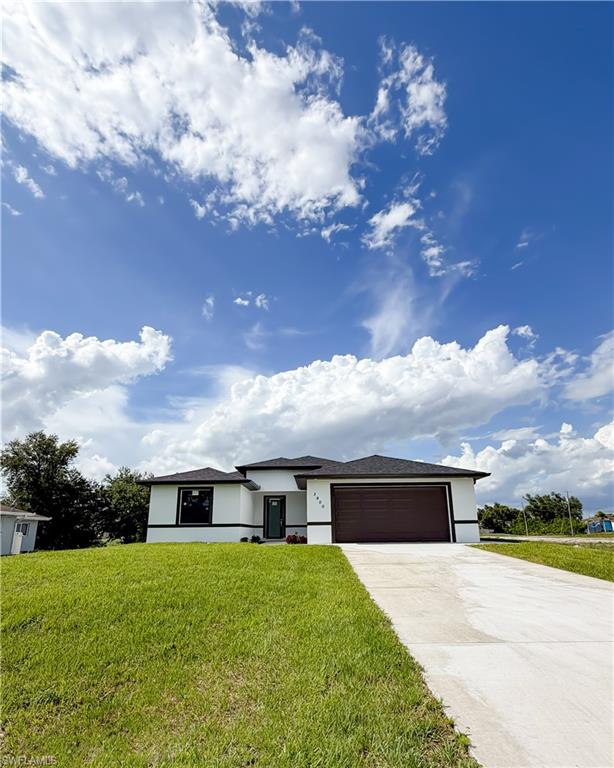 Contemporary single-story residence featuring a white stucco exterior with black trim accents