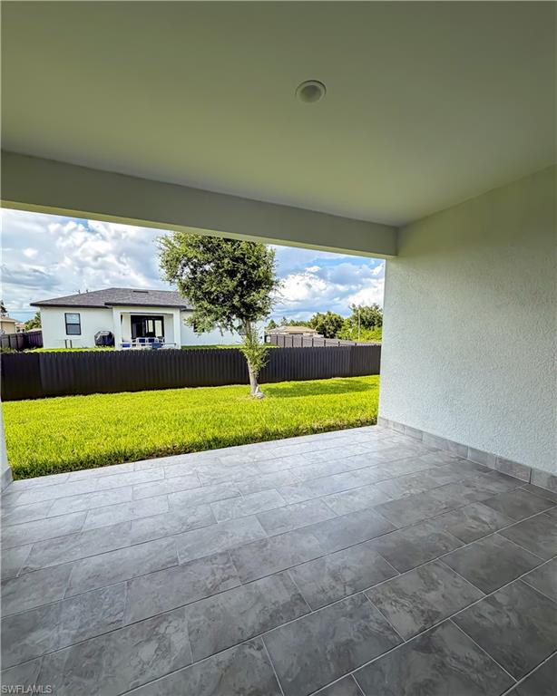 Covered patio featuring large format tile flooring and an integrated ceiling light
