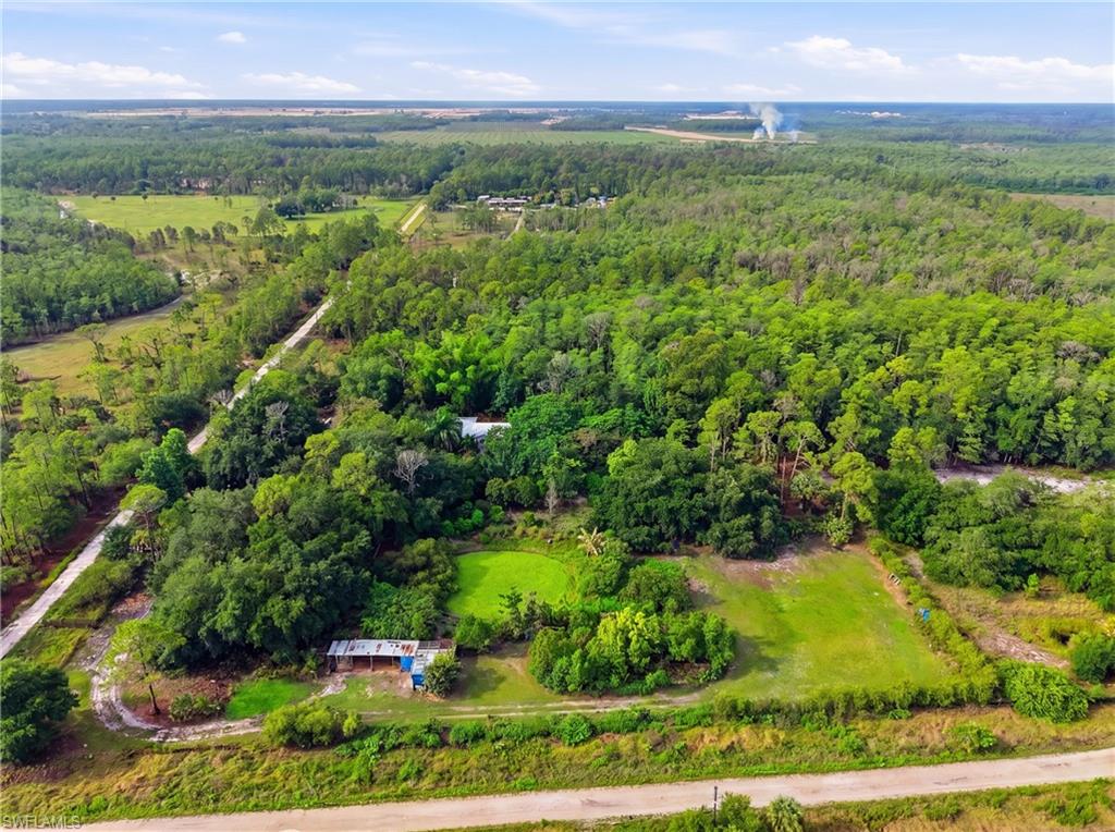 Aerial landscape featuring extensive wooded areas and cleared land