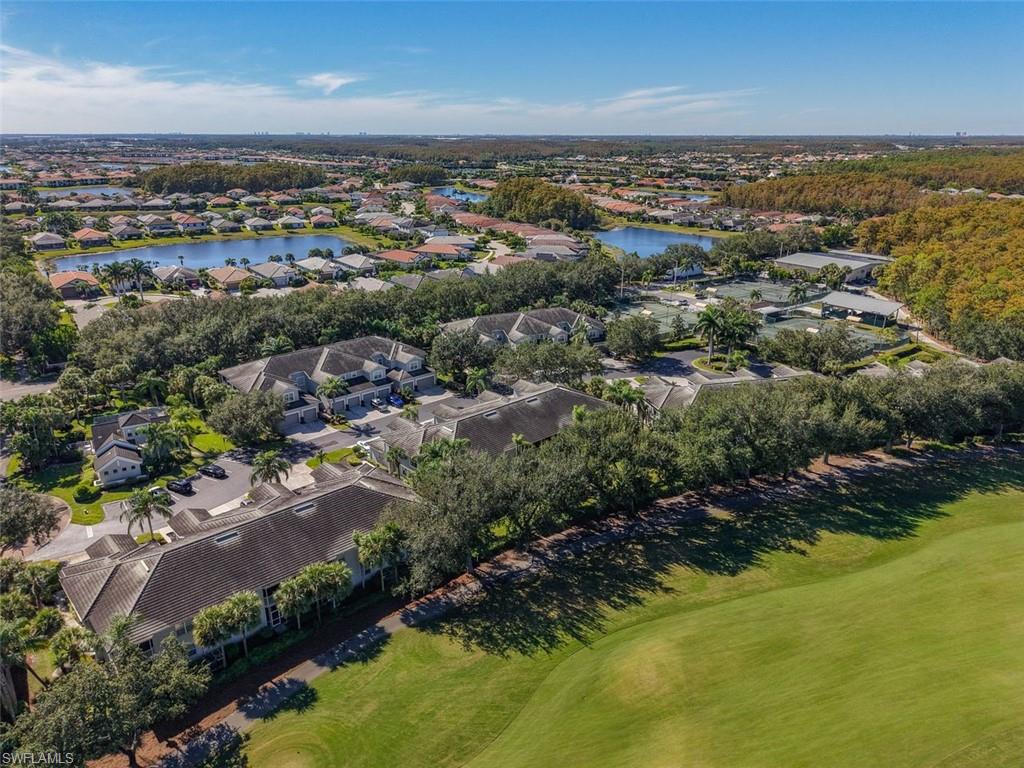 Aerial view of property and surrounding area with nearby suburban area