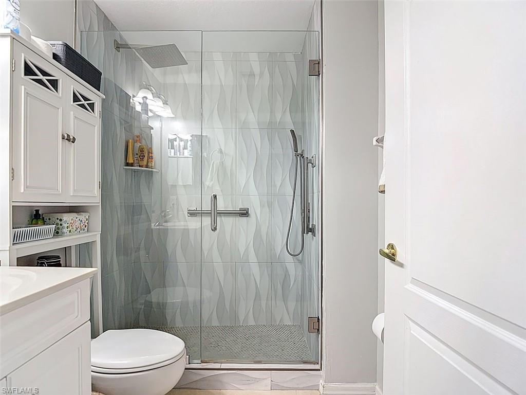 Full bath with vanity and a stall shower