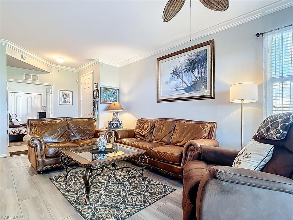 Living room featuring ornamental molding and wood finished floors