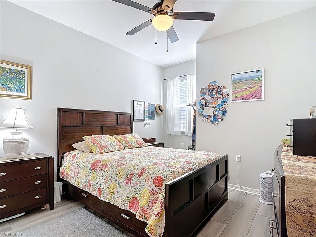 Bedroom with wood tiled floors and a ceiling fan
