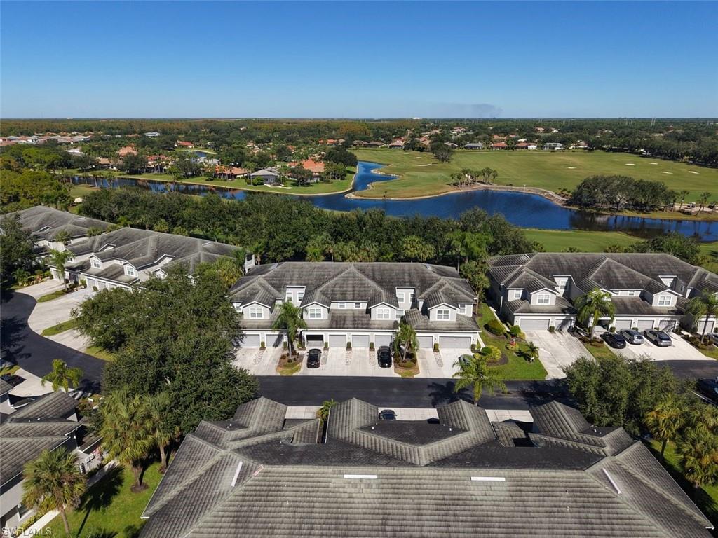 Aerial view of residential area with a nearby body of water and a golf club
