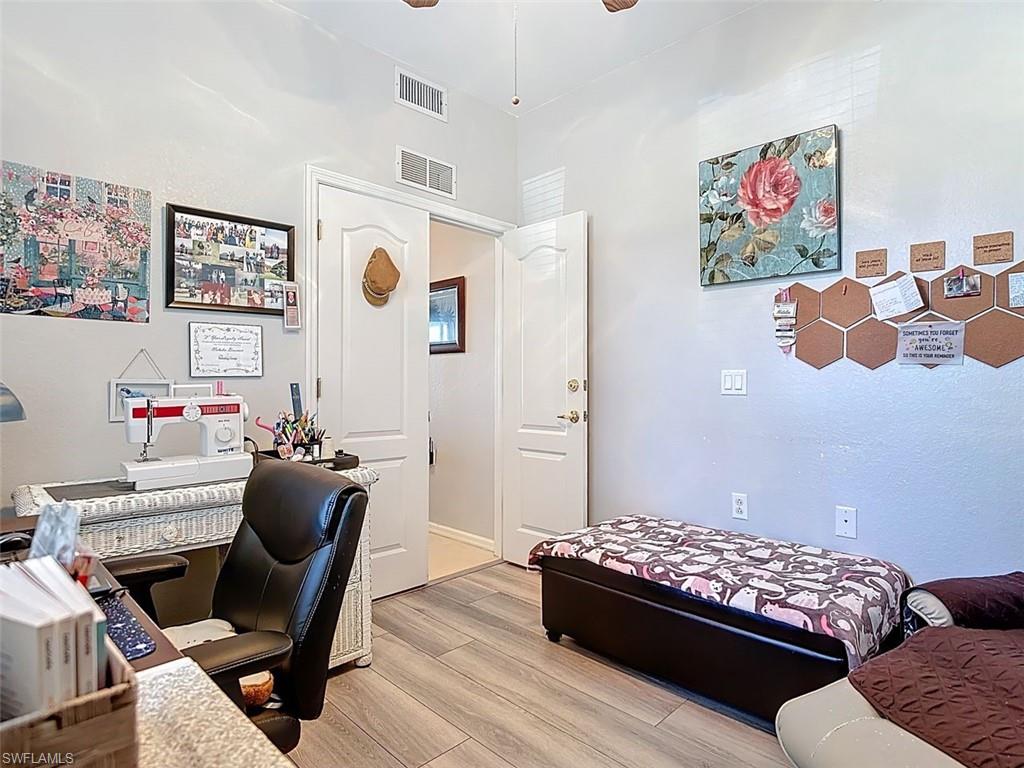 Home office featuring light wood finished floors and a ceiling fan