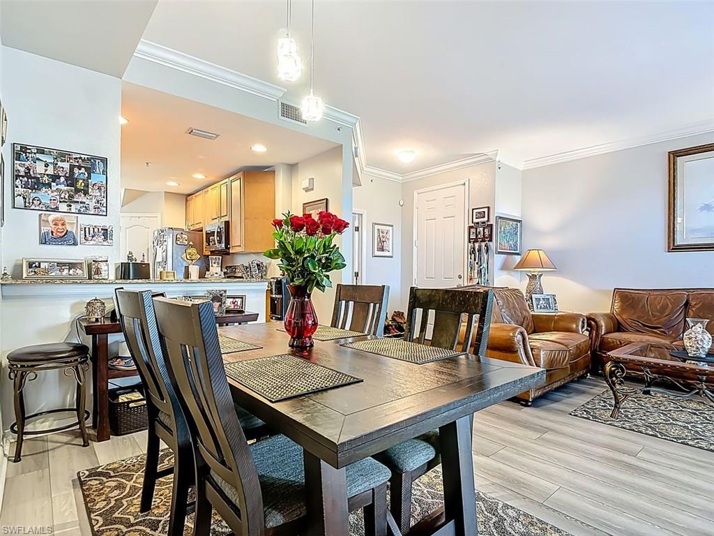 Dining room with ornamental molding and light wood finished floors