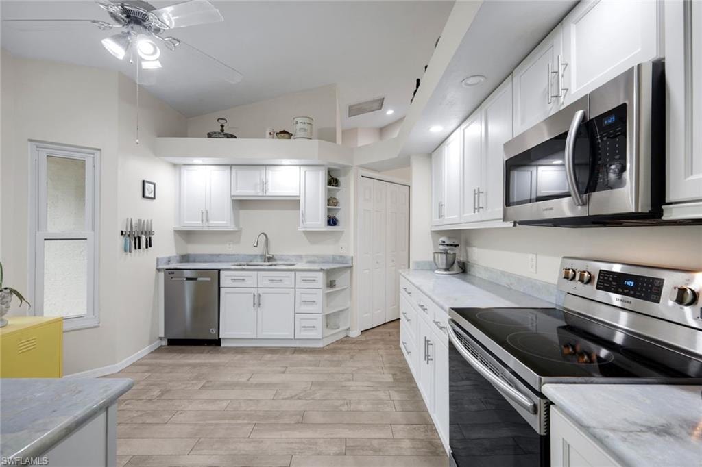 Kitchen features shaker cabinets and stainless appliances.