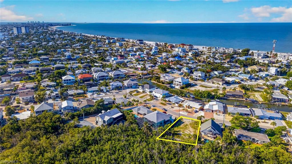 Aerial perspective showcasing a residential area with a prominent oceanfront - Virtually Edited Image