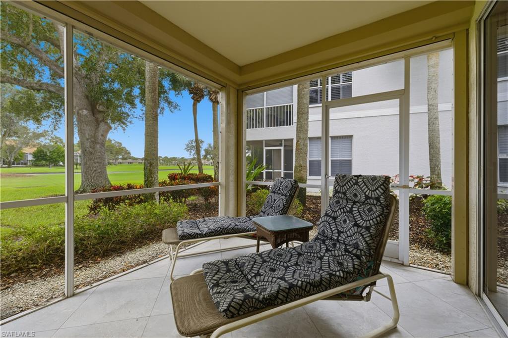 Sunroom featuring golf course view, healthy amount of natural light, and tile patterned flooring