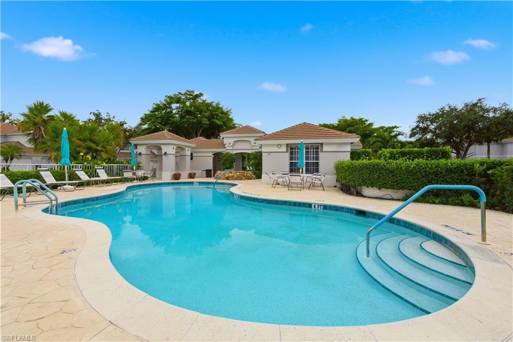 Community pool with a patio
