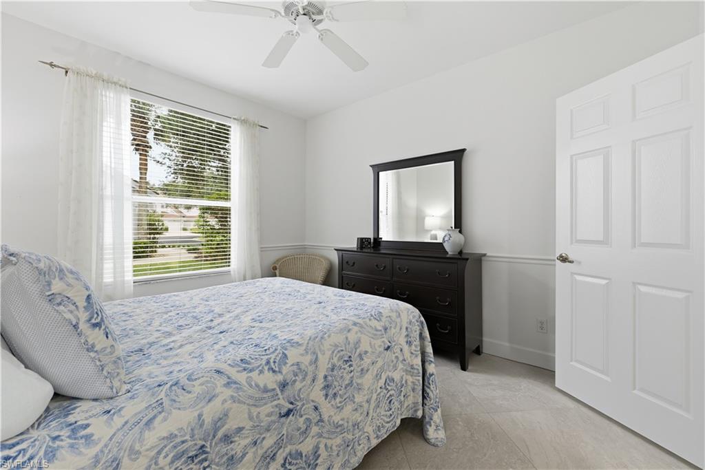 Bedroom with ceiling fan and light tile patterned floors